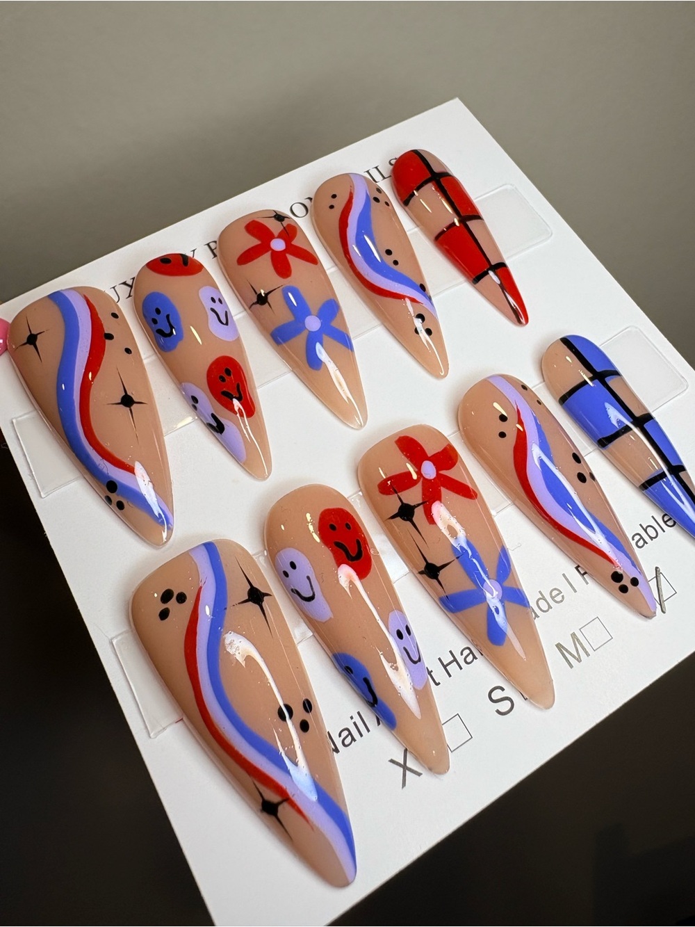 Handpainted Nude Stiletto Press-On Nails with Red & Blue Accents - Picture 3 of 3